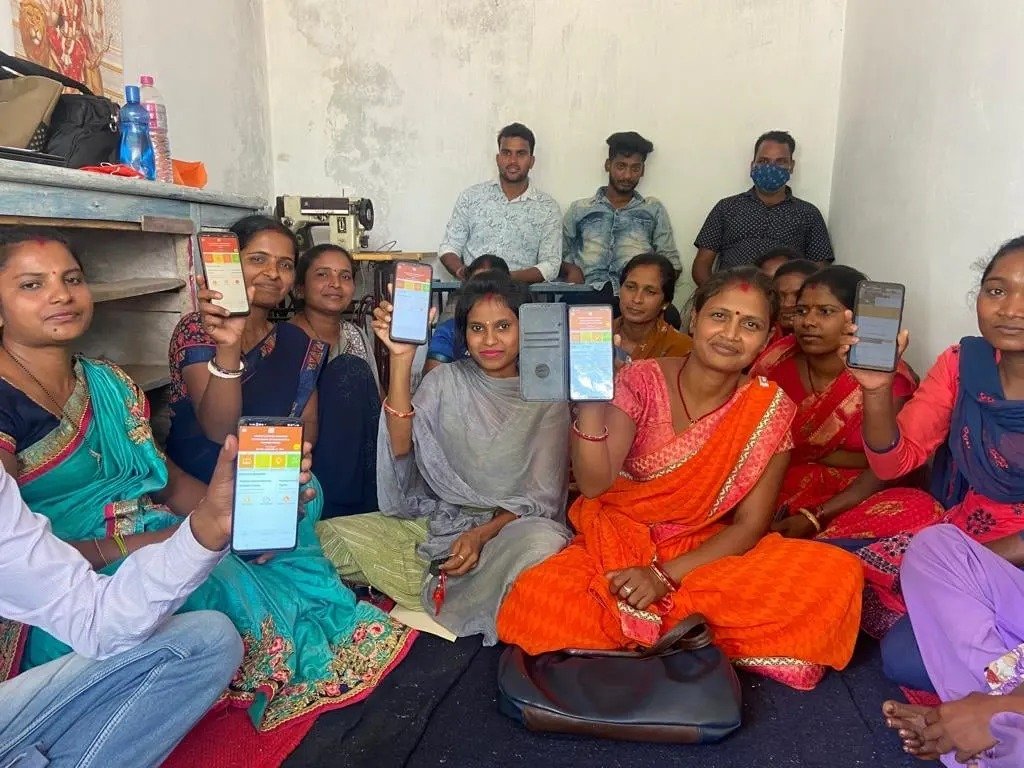 Community members holding up phones during a digital banking session