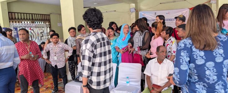 Group gathered indoors at a community event, with a banner for Civilian Welfare Foundation visible in the background